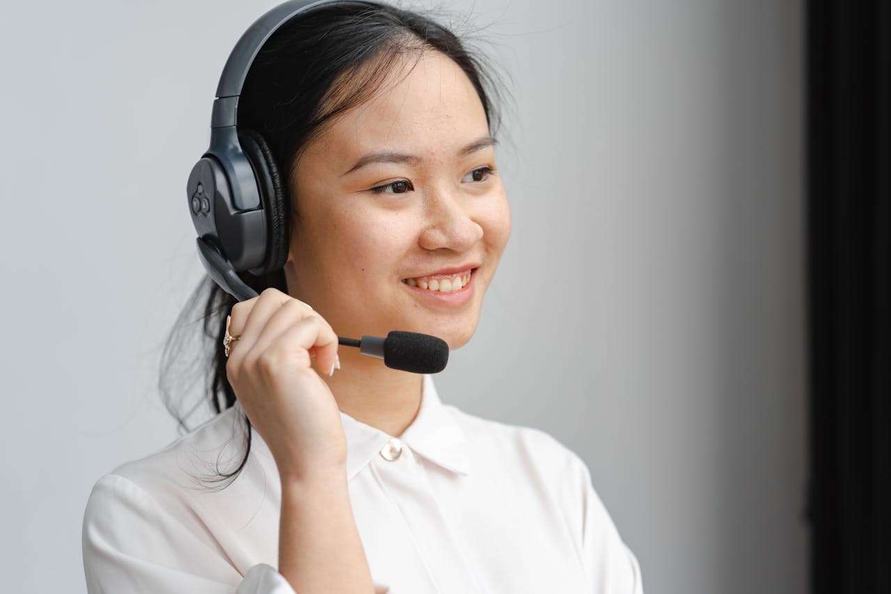 Smiling call center employee using a headset for effective customer communication.