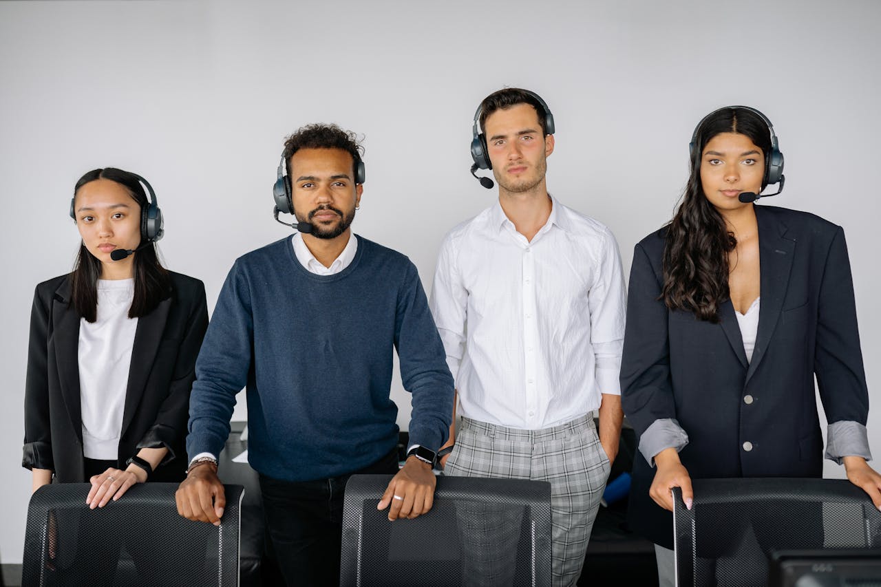 A diverse team of customer service agents wearing headsets, ready to assist.